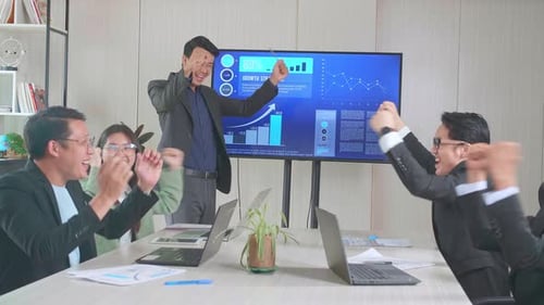 Young Asian Businessman Presentation To His Business Colleagues, They're Happy And Celebrate