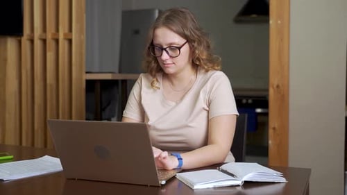 Woman Works on Computer in Home Setting