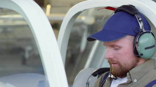 Mechanic Testing Headset in Pilot Cabin