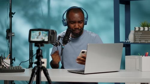 Vlogger Reading Bad News on Camera and Holding Smartphone