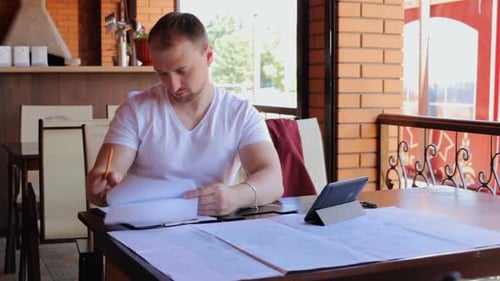 Construction engineers checks the blueprints of the business center.