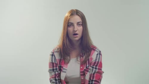 Surprised Woman Puts Hand Over Her Mouth