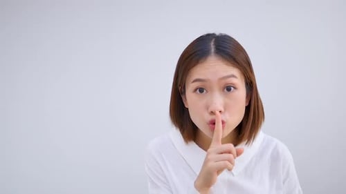 Young Woman Gestures for Silence, Close Up