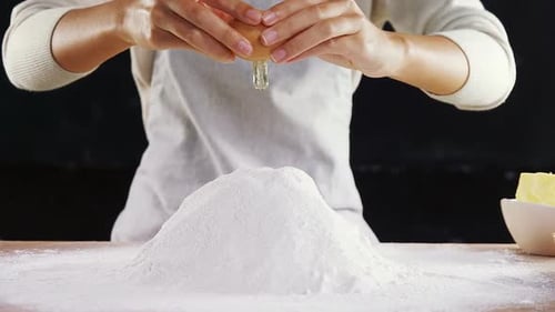Adding Egg To Flour For Baking At Home