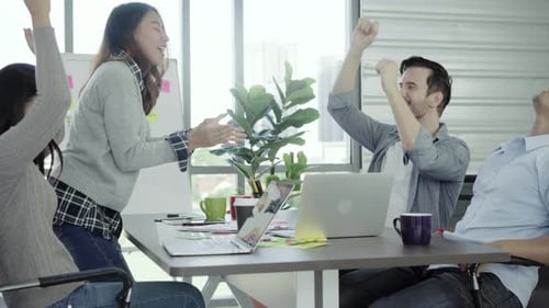Business women and men enjoy and having fun dancing while working in her office