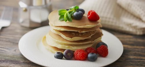 Pancakes Stacked High with Berries and Mint