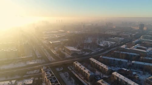 Snowy City Crossed By Road Under Blue Sky at Bright Sunset