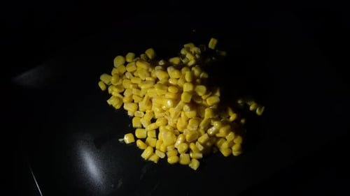 Fresh Yellow Sweet Corn Kernels on Black Surface
