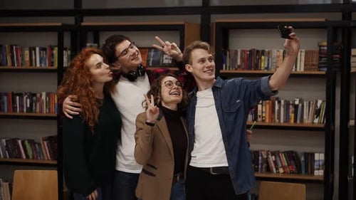 European Students Group of Four Take Selfie in the College or University Library