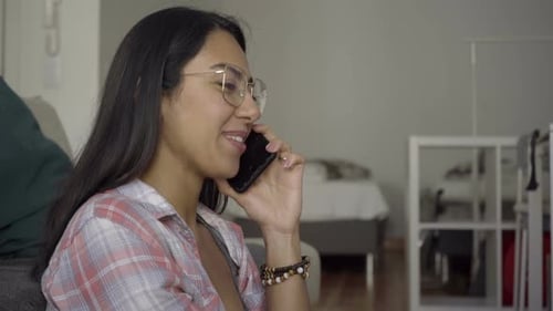 Close Up Shot of Smiling Young Woman Talking on Phone