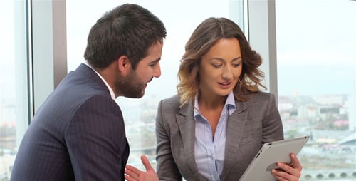 Business Meeting Reviewing Data on Tablet Indoors
