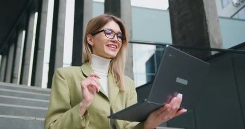 Woman Waving During a Video Call on Laptop