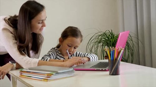 Woman and Child Learning Together with Laptop