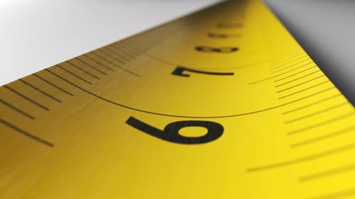 Camera moves along the yellow tape measure in endless loop. Close-up shot.