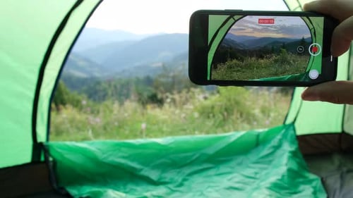 Photo on Smartphone From a Tent in the Mountains of the European Alps