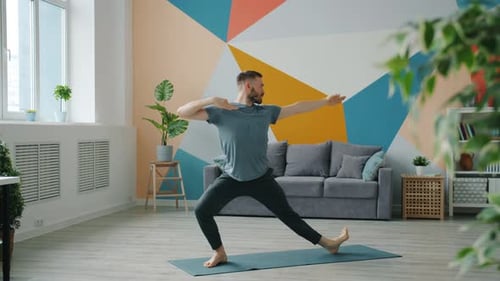 Professional Yoga Instructor Exercising at Home Doing Complex of Asanas Alone