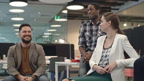 Laughing Colleagues Chatting in Office