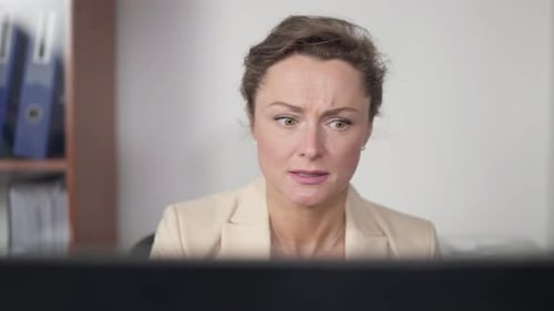 Portrait of Stressed Worried Caucasian Woman Working Online on Laptop Sitting in Office