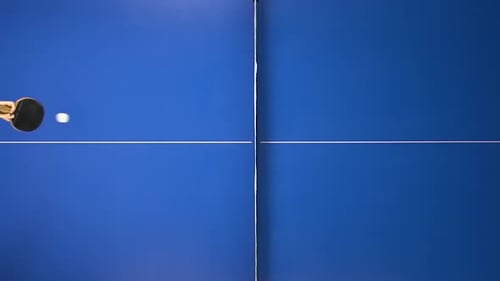 Ping Pong Concept. Two People Playing on a Blue Table, Slow Motion