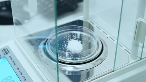 Scientist Using Precision Balance to Weigh Chemical Sample