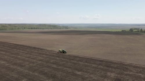 Tractor plows and cultivates the land for sowing