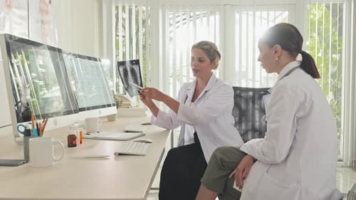 Female Doctors Discussing Chest X Ray in Clinic