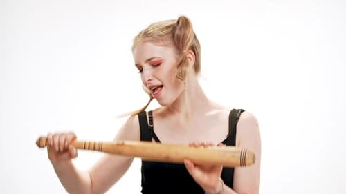 Young Adult with Baseball Bat Smiling in Studio