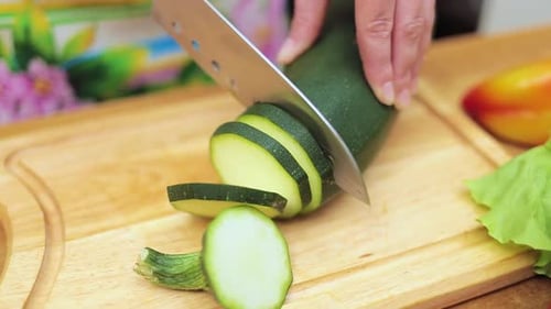 Slicing Fresh Zucchini on a Cutting Board