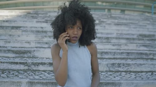 Mujer hablando por teléfono, comportándose emocionalmente, gesticulando