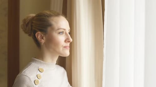 Woman Drinking Tea by Window