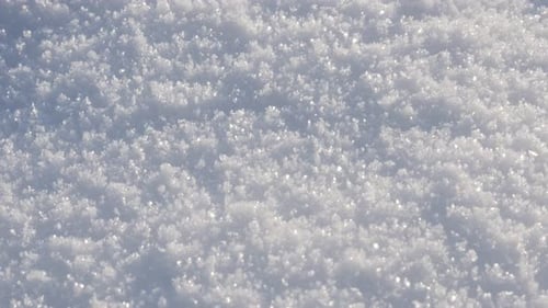 Milky white snow crystals close-up 4K 2160p 30fps UltraHD tilting footage - Sparkling frozen crysta