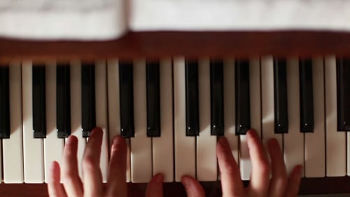 Overhead View of Piano Player's Hands on Keys