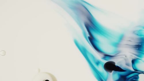 Abstract Turquoise and Black Ink Swirls in Liquid