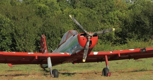 Old Airplane Parked on Rural Grassy Field