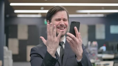 Frustrated Man Reacting Negatively to Phone Message
