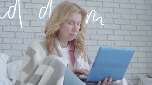 Woman Working on Laptop Coughing in Bed