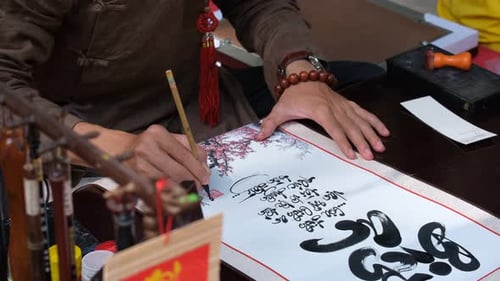 Vietnamese scholar writing calligraphy at lunar new year