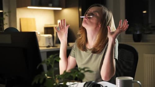 Woman Working Late Puts Pen on Upper Lip