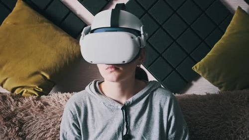 Woman Using VR Headset on Couch at Home
