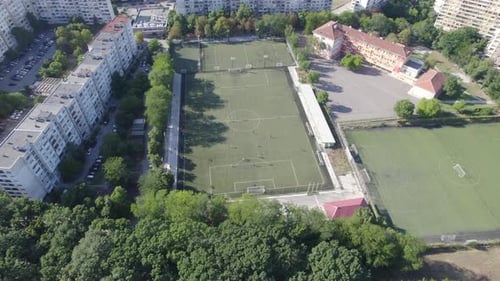 Aerial View of Soccer Stadium in the City Between the Blocks