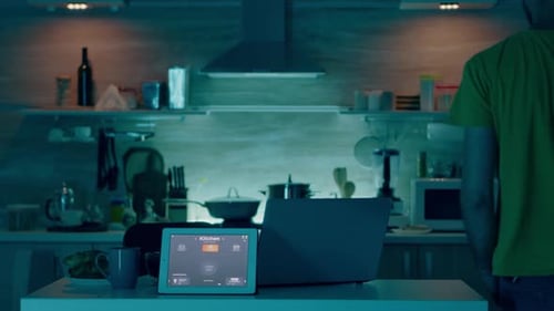 Man Uses Smart Home Technology in Kitchen