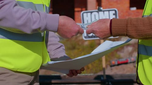 Builders Exchange Money for Plans, Shake Hands