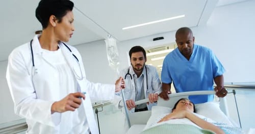 Doctors rushing a patient in icu