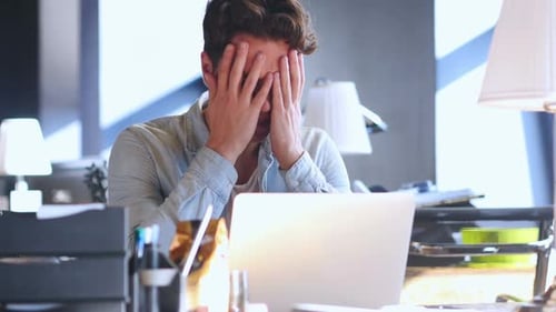 Young Adult Man Works at Laptop