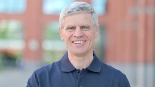 Smiling Mature Man Gives Thumbs Up Gesture