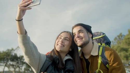 Smiling Couple Takes Selfie During Hike