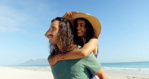 Happy Couple Piggyback Ride on Beach Day