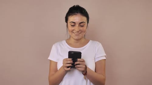 Smiling Woman Using Smartphone