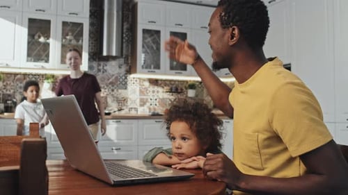 Family Video Chatting Together at Kitchen Table