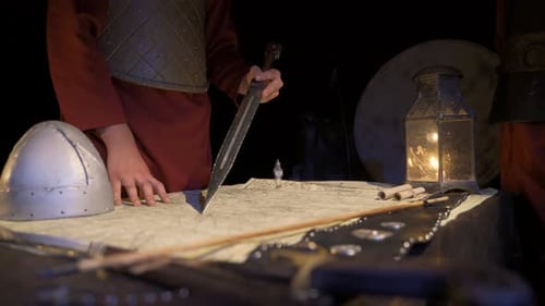 Medieval Military Strategy Around Map in Dim Light